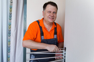 Man father installs towel dryer balcony.