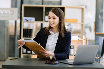 Beautiful woman lawyer working and gavel, tablet and laptop in front, Advice justice and law concept