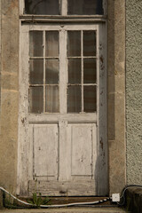 Old weathered wooden entry door of a rustic house