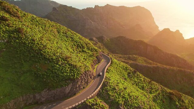 Aerial view of green volcanic landscape with mountain road in Tenerife