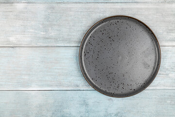 Beautiful empty plate with blue concrete background flat lay top view