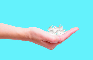 Pile of Tooth Models in Hand on Blue