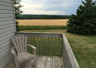 relaxing at the cottage on a porch while viewing beautiful yellow fields in the background