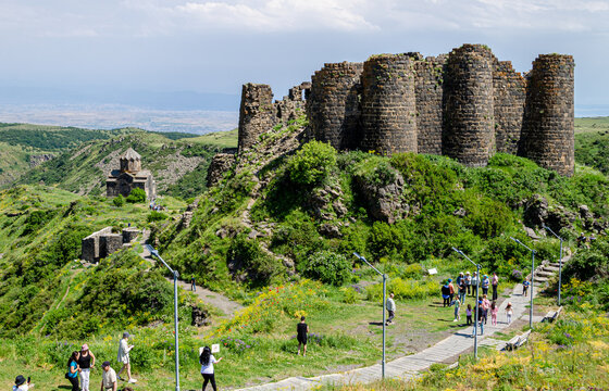 Ruins of the medieval fortress Amberd, Armenia. Lots of tourists are walking around.