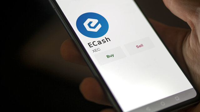 March 11 2023 London UK. An investor's analyzing the eCash  coin on screen. A phone shows the crypto's prices to invest in XEC