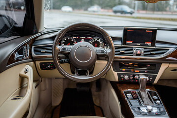 Luxury modern car interior business class. Steering wheel, shift lever, speedometer, display,...