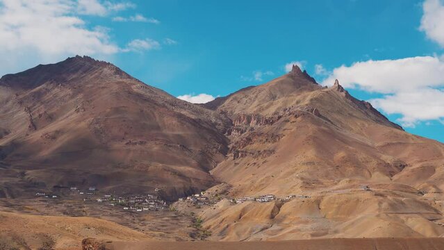 4K shot of Chicham village as seen from the Chicham bridge near Kibber in Spiti Valley, Himachal Pradesh, India. Village under the mountain divided by a fault line in the mountain in India. 