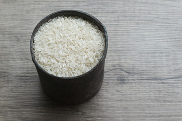 White Rice, rice in the iron container on the wooden background