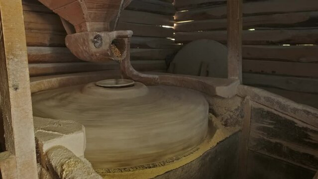 Working old water powered grist mill made of stones and wood, 4k