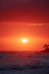 Orange sunlit skies with sunrise over the ocean at Burleigh Heads, Gold Coast Australia