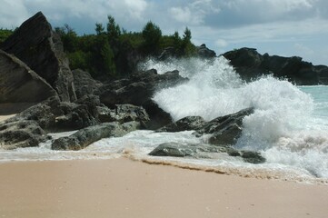 waves crashing on volcanic rock on the beach of Bermuda