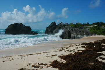 waves crashing on the volcanic rock on a beach in the island of Bermuda