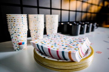 Decorations for a child's birthday party. Birthday in the playroom. Disposable children's party dishes. Selective focus.