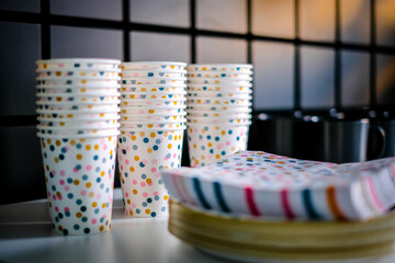 Decorations for a child's birthday party. Birthday in the playroom. Disposable children's party dishes. Selective focus.