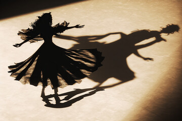 The shadow of a dancing woman and man, falling on the dance flor, cartoon idea, created with Generative AI
