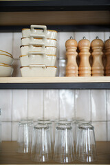 Kitchen shelves with various ceramic plates and glass cups