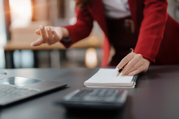 Fototapeta premium Beautiful young teen asian business woman meeting at on computer laptop with planning working on financial document, tax, exchange, accounting and Financial advisor