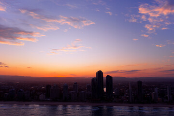 Colouful aerial cityscape sunset silhoutte view over Gold Coast skyline and beach	