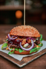 Healthy burger vegan and nonvegan style food dish. Restart burger sets on wooden plate. Meaty juicy burgers with vegetables. Culinary made dish. closeup shot and wide shot. Ham. Unhealthy junk food. 