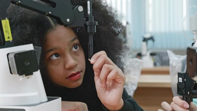 Group Kid teen child enjoy Machine Learning Robot arm is Moving Under coding Control robot at stem technology class, stem education for digital automation learn for use artificial intelligence ai