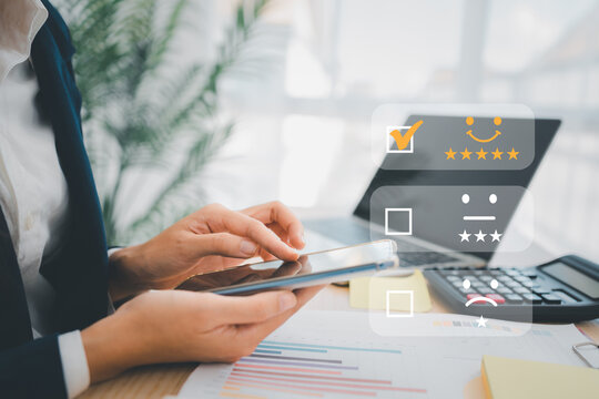 Businesswoman gives ratings to service experience on a smartphone, Service Provider Satisfaction Ratings and Evaluations,  Satisfaction concept and Customer services