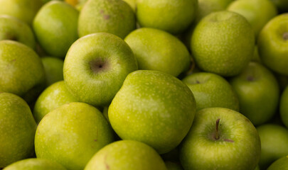 appetizing green apples on counter in market