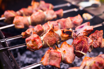 Juicy cuts of meat are grilled on grill. Outdoor recreation concept
