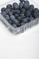 Large blueberries in a decorative container. International day without diets. On a white background. Close-up.