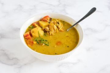 soto ayam, chicken soto is Indonesian traditional dish with yellow soup 