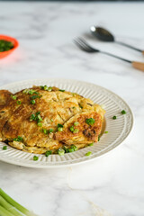 telur goreng, fried egg or omelette in white ceramic plate