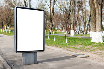 Empty billboard lightbox on green city street in PNG isolated on transparent background
