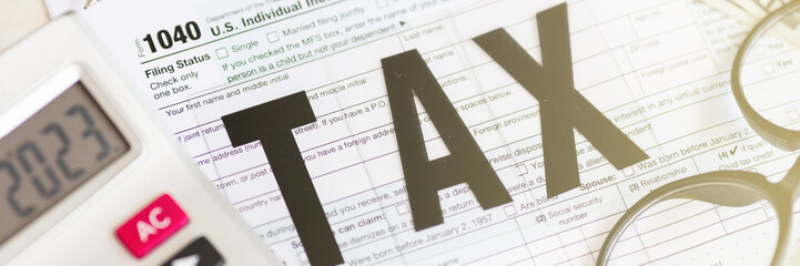 Fototapeta premium Individual income tax return form for tax payment on working desk. Calculation tax return in 2023