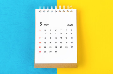 The May 2023 Monthly desk calendar for 2023 year on blue and yellow background.