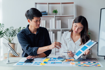 Obraz premium young husband and wife working at office by new project and happy