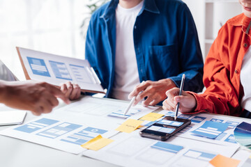 happy young asian couple working together from home talking discussing using graph stock.