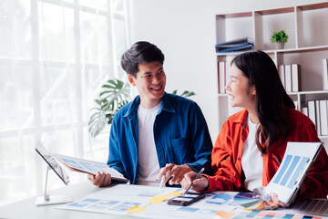 Man and woman ecommerce business workers using smartphone and Chart plan at the office.