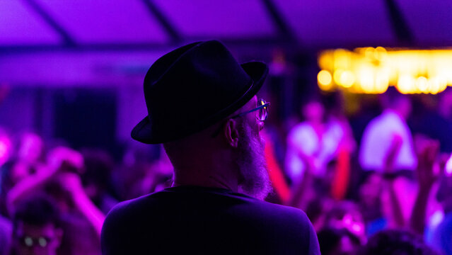 close-up of a deejay behind while playing in the disco