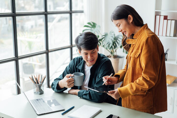 young husband and wife working at office by new project and happy.