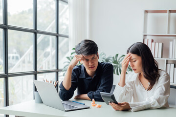 young husband and wife working at office by new projack and happy