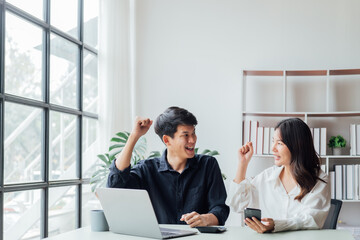 Fototapeta premium young husband and wife working at office by new project serious and happy