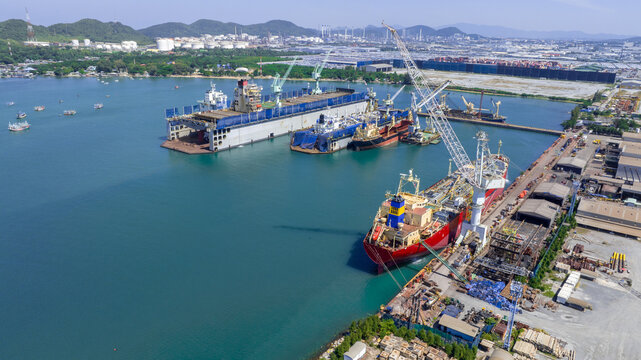 Oil tanker ship at dry dock concept maintenance service. working at dry dock. Insurance and Maintenance Crude tanker Ship concept. Freight Forwarding Service maintenance Insurance