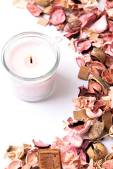 photo a lot of dried plants and a lit candle