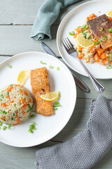Pan fried salmon fillet with brown rice and vegetables on plates with two serving variations