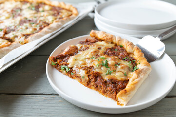 Pizza with stewed meat and cheese topping