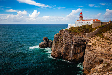 Fototapeta na wymiar white lighthouse on cliffs at algarve portugal