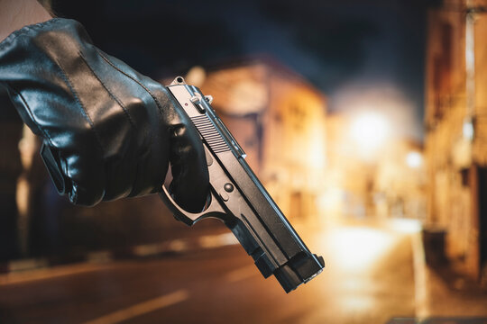 street crime concept. man robs on the street. The search of the criminal. Death threat. Personal weapons for self-defense.