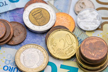 Assortment of coins on bank notes from different countries.