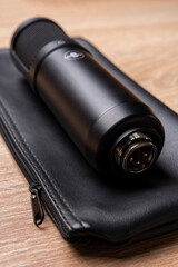 xlr male connector of the professional condenser microphone on black leather case