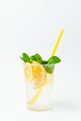Vertical shot of a fresh lemonade in a to go plastic glass with mint leaves.