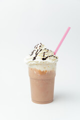 Vertical shot of a chocolate milkshake with a lot of whipped cream on top.